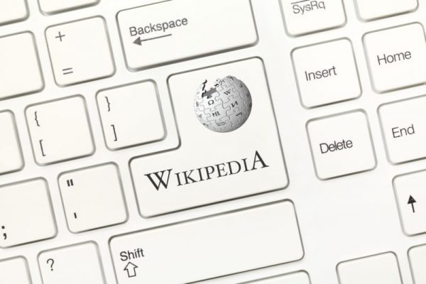 Close-up view on white conceptual keyboard - Wikipedia (key with logotype)
